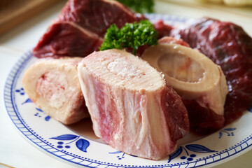 Marrow bones and beef meat on a plate