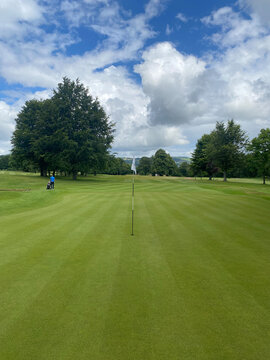 golf flag on golf green at a parkland golf course in the UK during summer 