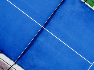 aerial view of a blue artificial grass paddle tennis court
