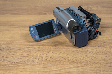 Handycam, Camcorder, Video camera record on a wooden table, Vintage video camera style, Recording memory concept, Old school style, Mini dv, Retro video camera.