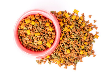 Pink bowl with dry cat food on a white isolated background. Template, design.