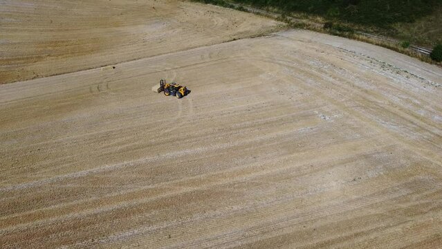 British Agricultural and Harvesting Fields Farms at Sunset Time. High Angle Footage taken with drone's camera on a hot summer day of England. Agricultural Farms and Working Machines at Dunstable Downs