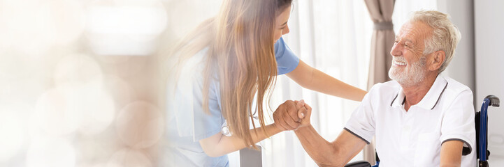 Web banner Man being cared for by a private Asian nurse at home suffering from Alzheimer's disease...