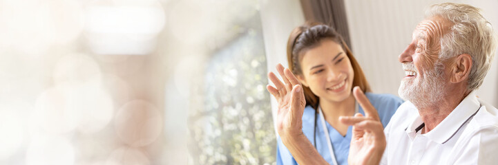 Obraz premium Web banner Man being cared for by a private Asian nurse at home suffering from Alzheimer's disease to closely care for elderly patients with copy space on left