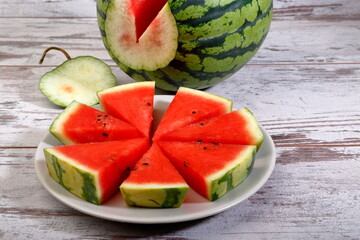 Fresh sliced watermelon composition on wooden background.