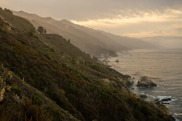Fototapeta na wymiar Hazy Cliffs Drop Into The Pacific Ocean Along The California Coast