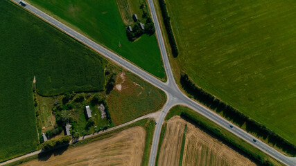 Aerial view of cross roads on single track road in the europe