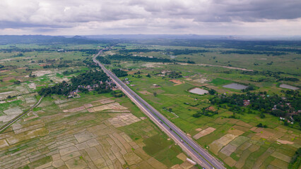 Aerial view of road going through greenery, Roads through the green forest, drone landscape