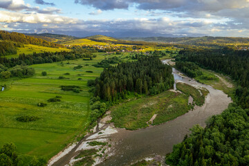 Bialka River in Podhale region, High tatras mountains in Poland at sunset. Drone View