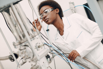 Scientist african american woman working in laboratory with SNSPD electronic tech superconducting...