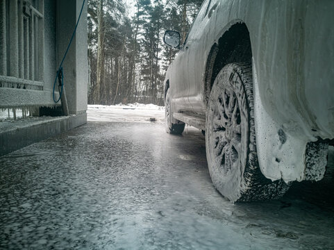 white offroad car stand on carwash winter