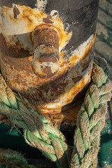rusty bollard and rope on ship deck