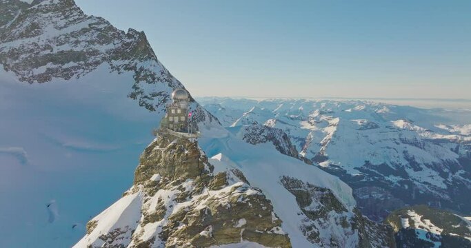 Aerial drone fly over Sphinx observatory and Aletsch glacier on Jungfraujoch, Swiss Alps, Switzerland. Jungfrau top of europe in interlaken one of the highest mountain in the world on winter sunny day