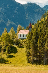 Beautiful alpine summer view with the famous Lourdes chapel at the Tannheimer Tal valley, Tannheim, Tyrol, Austria