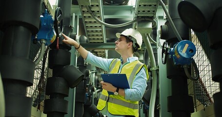 Portrait Professional Inspector Engineer foreman in hardhat working checking the valve pipelines...