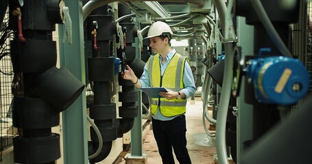 Portrait Professional Inspector Engineer foreman in hardhat working checking the valve pipelines...