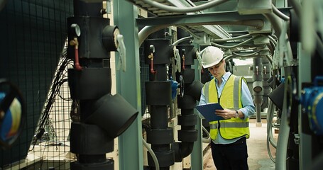 Portrait Professional Inspector Engineer foreman in hardhat working checking the valve pipelines...