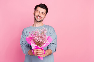 Portrait of positive person arms hold fresh flowers bouquet isolated on pink color background