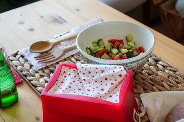 Reusable napkins on a wooden desk with some food and drink