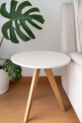 End table, round coffee table isolated near the couch