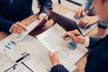 Group of business people meeting together Pointing to the graph assess business profits