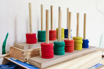 Soroban abacus in wood and colored, with different colors, used for children's learning. Formed by...