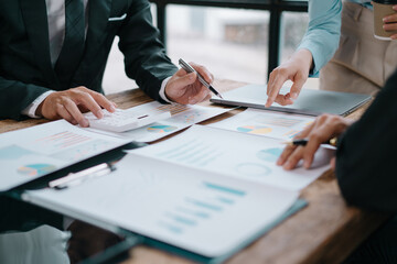 Group of business people meeting together Pointing to the graph assess business profits