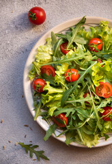 Fresh vegetable salad with tomatoes, arugola, lettuce and other ingredients, healthy eating
