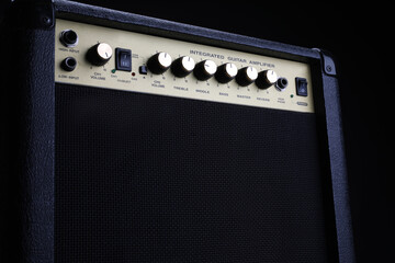 Black guitar amplifier, amp on a black background, close up. Instruments equipment.