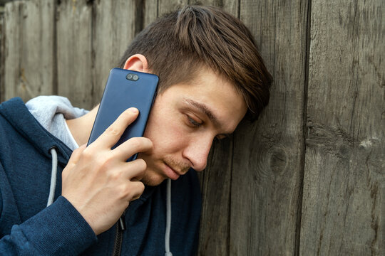 Sad Young Man with a Phone