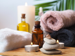 Obraz na płótnie Canvas Bottled massage oils, lit candles, towels