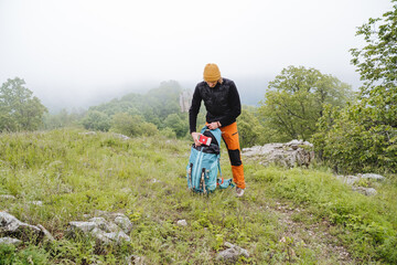 A first aid kit is in the pocket of a backpack, important travel equipment, a first-aid kit with medicines, put a first-aid kit of medical care in your bag.