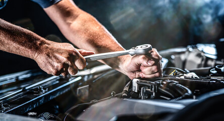 Auto mechanic working in garage. Repair service. - 525885573