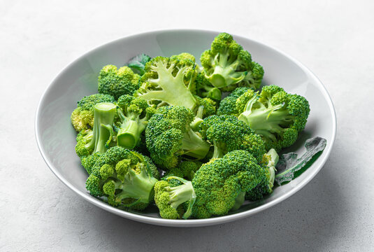 A plate of sliced broccoli close-up. Healthy food. Side view.