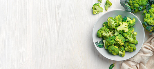 A plate of broccoli on a white wooden background. Cooking broccoli.