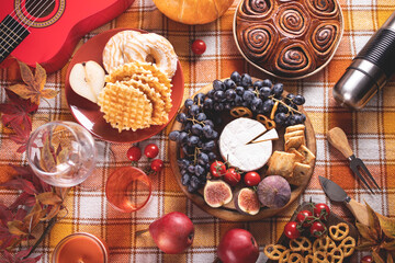 Obraz na płótnie Canvas Autumn outdoor picnic set or dinner for celebration Thanksgiving Day. Holiday party. Festive table. Snacks, friuts,pie, vegetables, wine glasses.