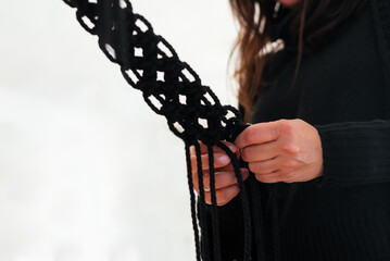 Close up of woman's hands making macrame