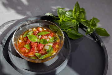 Tomato and fresh basil on concrete