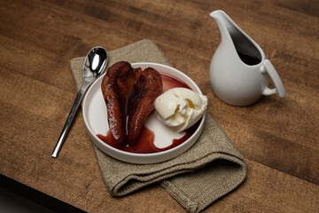 Pouched pear in wine sauce and ice cream