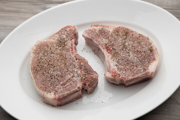 Raw seasoned pork chop