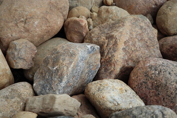 A pile of gray stones together forming a texture. Natural stones texture. gray rocks. Stone photography. Natural textures. Stacked rocks and stones. Pile of rocks