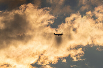 the silhouette of a propeller airplane on the evening sky