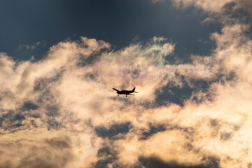 Fototapeta na wymiar the silhouette of a propeller airplane on the evening sky