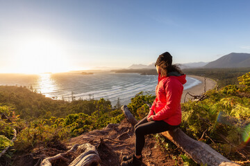Adventurous Woman Hiker overlooking Sandy Beach on the West Coast of Pacific Ocean. Canadian Nature...