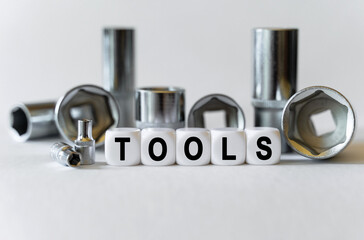 On a white background, a set with tools and white cubes with the inscription - tools