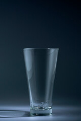 Empty Glass tumbler on black background, still life