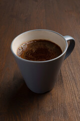 Close up cup of delicious fresh natural coffee on wooden table