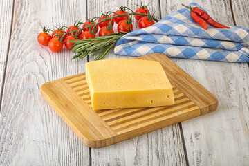 Piece of natural organic cheese over board