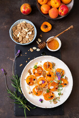 Grilled apricots with buratta cheese , granola and honey. Summer breakfast
