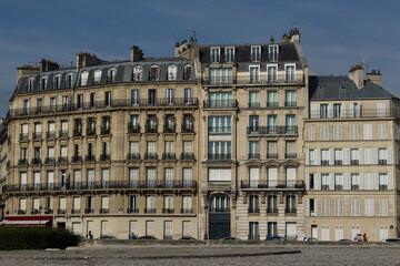 Typical Parisian apartment complex seen in the mid-afternoon summer sun with a clear sky overhead